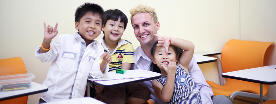 Female-Teacher-With-Asian-Students